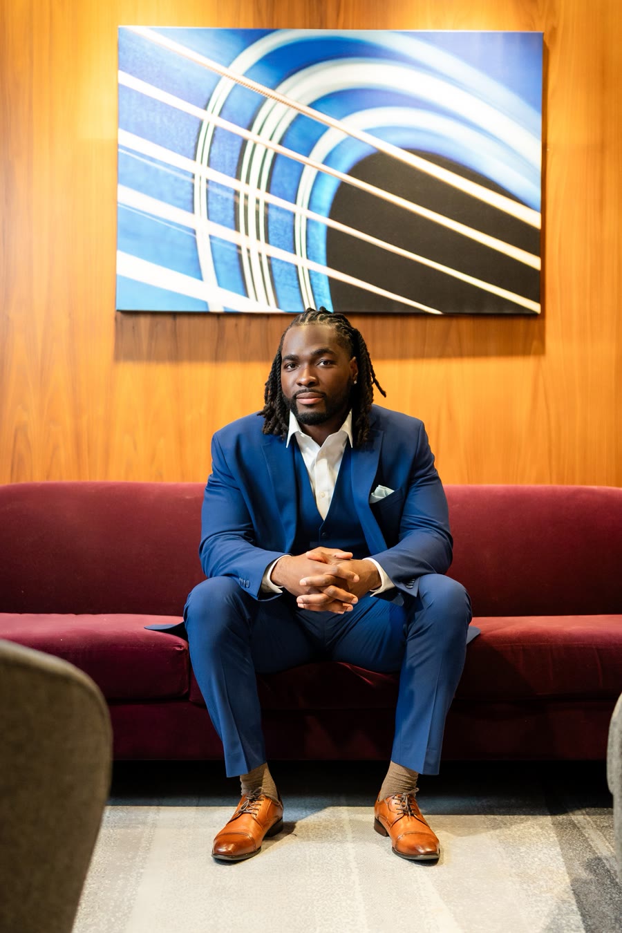 Miken Daris seated in a blue suit